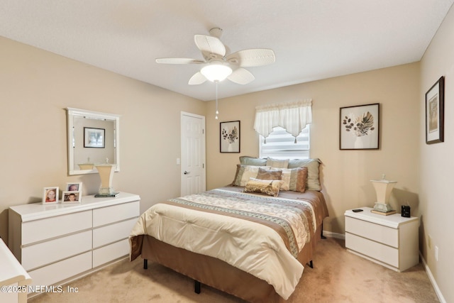 bedroom featuring light colored carpet and ceiling fan