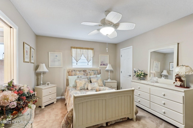 bedroom featuring light carpet and ceiling fan