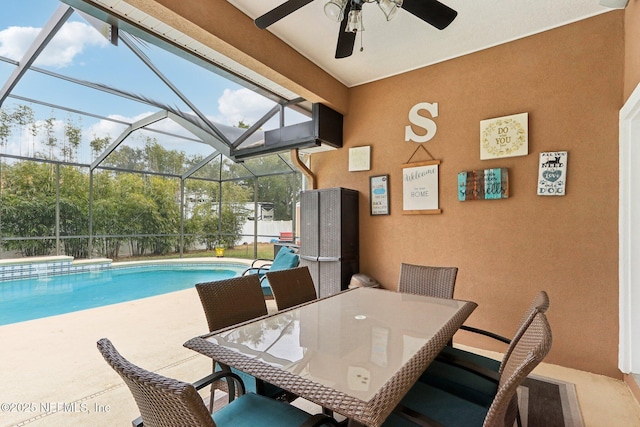 view of swimming pool featuring a lanai and a patio