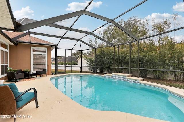 view of swimming pool with a lanai and a patio area