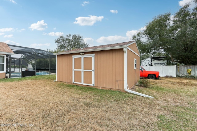 view of outbuilding with a pool and a yard