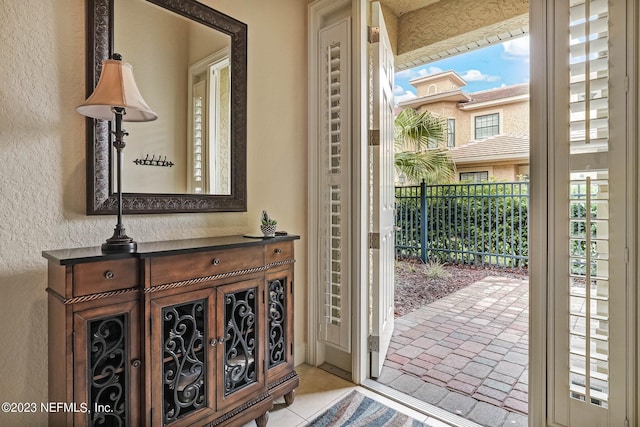 doorway with light tile patterned flooring