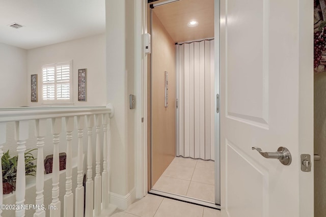 bathroom featuring tile patterned floors and elevator