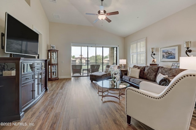 living room featuring hardwood / wood-style floors, ceiling fan, and vaulted ceiling