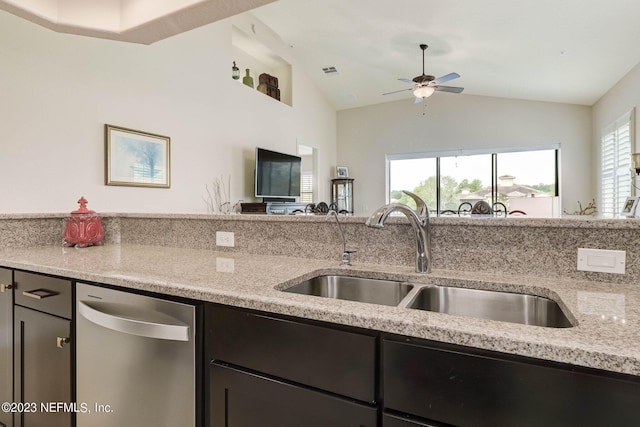 kitchen featuring ceiling fan, light stone counters, lofted ceiling, and sink