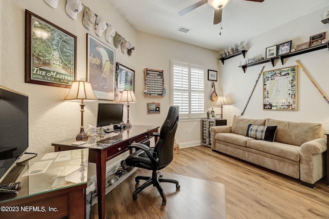 office area with light hardwood / wood-style flooring and ceiling fan