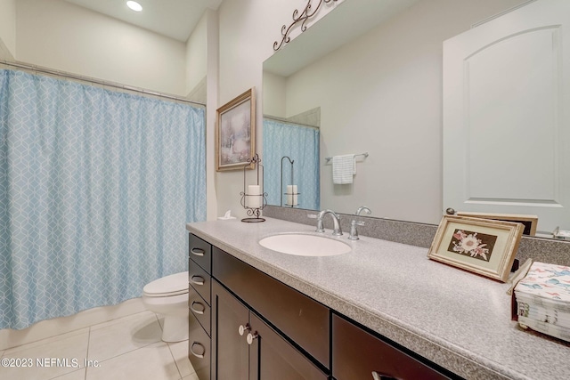 bathroom featuring tile patterned flooring, vanity, and toilet