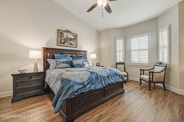 bedroom featuring ceiling fan, light hardwood / wood-style floors, and lofted ceiling