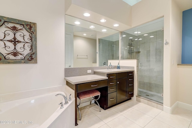 bathroom featuring tile patterned flooring, vanity, and plus walk in shower