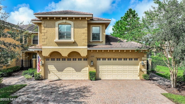 mediterranean / spanish-style home featuring a garage