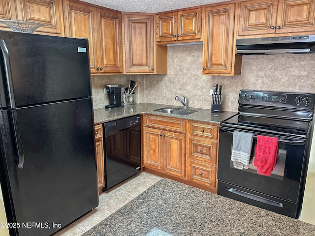 kitchen featuring black appliances, tasteful backsplash, dark stone countertops, sink, and light tile patterned floors