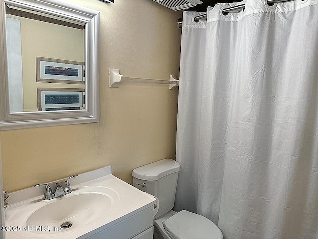 bathroom featuring toilet and vanity