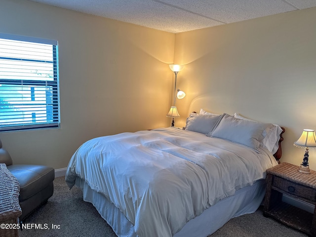 bedroom with carpet floors and a textured ceiling