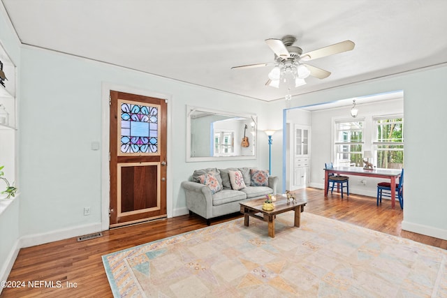 living room featuring ceiling fan and light hardwood / wood-style flooring