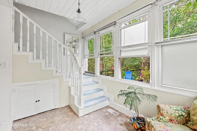 stairway featuring lofted ceiling