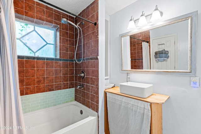 bathroom featuring vanity, shower / bath combination with curtain, and a textured ceiling