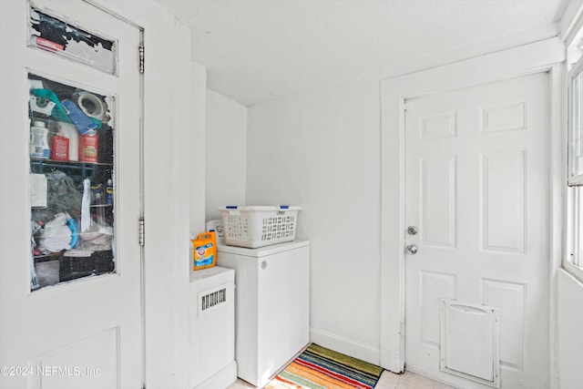 laundry room featuring washer / clothes dryer and light tile patterned flooring