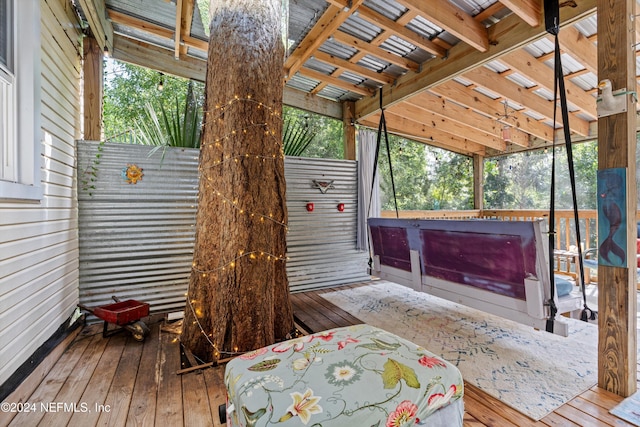 wooden deck with a hot tub