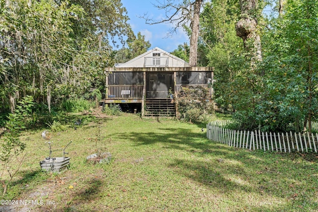 view of yard with a deck and a sunroom