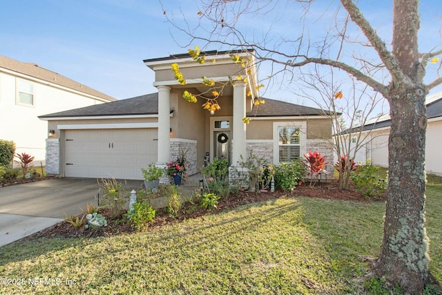 view of front of home with a garage and a front lawn