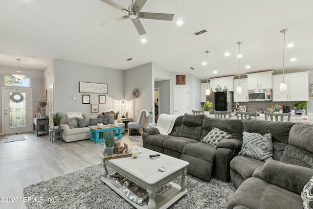 living room with light hardwood / wood-style floors and ceiling fan