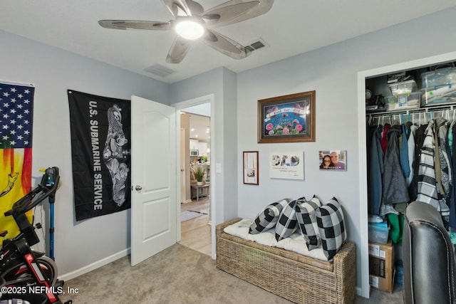 carpeted bedroom featuring a closet and ceiling fan