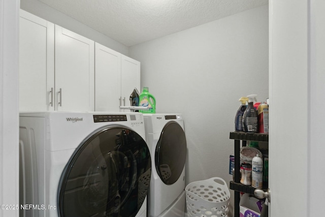 clothes washing area featuring cabinets, a textured ceiling, and independent washer and dryer