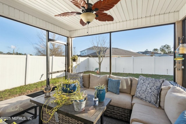 sunroom featuring ceiling fan