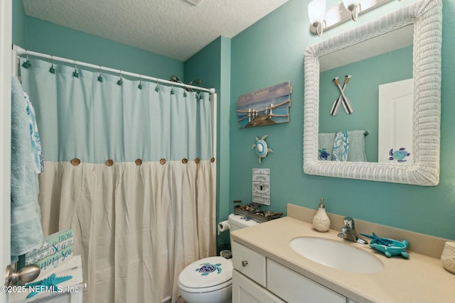 bathroom featuring a shower with curtain, vanity, toilet, and a textured ceiling