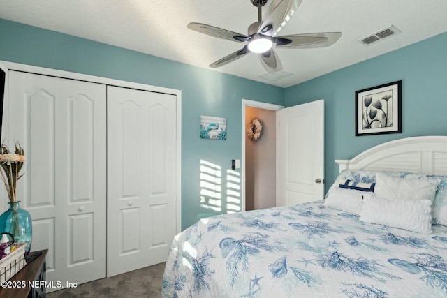 carpeted bedroom featuring ceiling fan and a closet