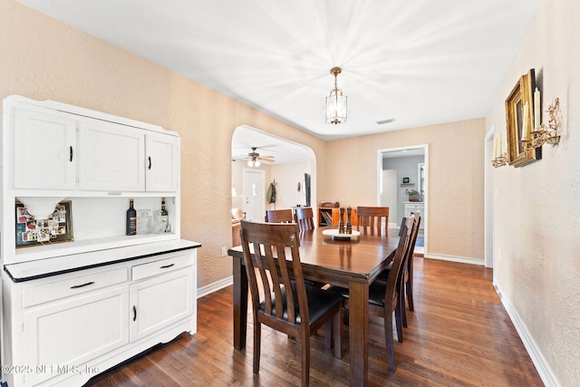 dining space featuring ceiling fan and dark hardwood / wood-style flooring