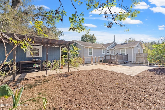 back of property featuring a pergola, a deck, and a patio area