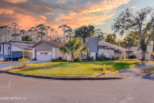 view of front of home with a lawn and a garage