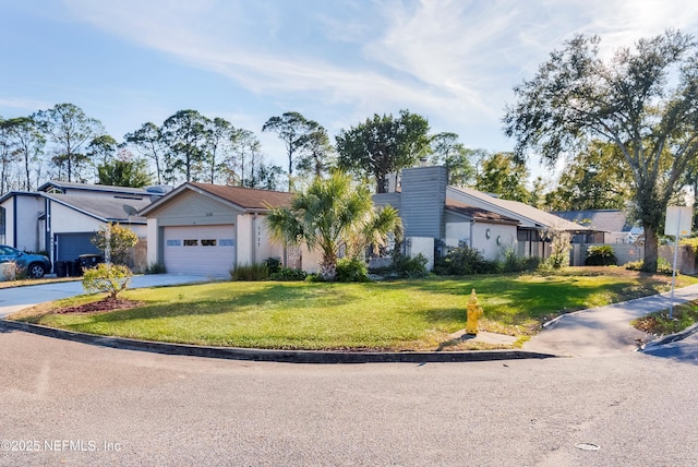 view of front of property featuring a garage and a front lawn