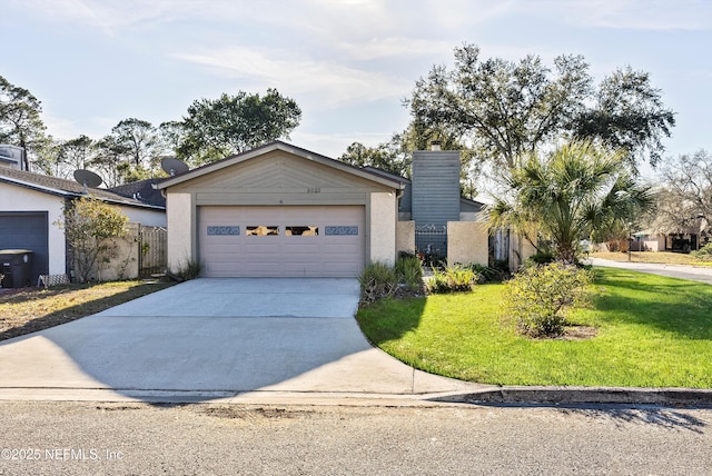 ranch-style house featuring a garage and a front lawn