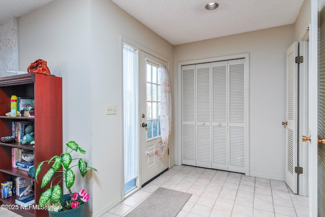 entryway with a textured ceiling