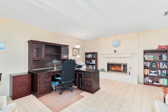 tiled office space with a fireplace