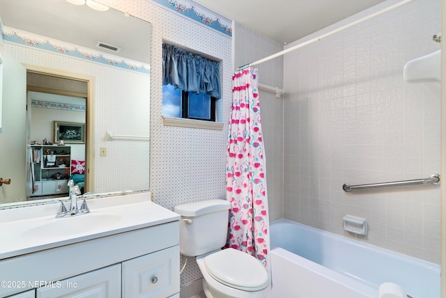 full bathroom featuring shower / bath combo, vanity, and toilet