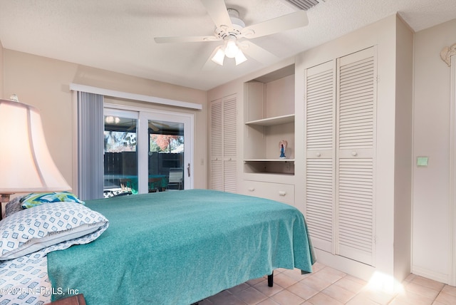 bedroom featuring access to exterior, ceiling fan, light tile patterned flooring, and a textured ceiling