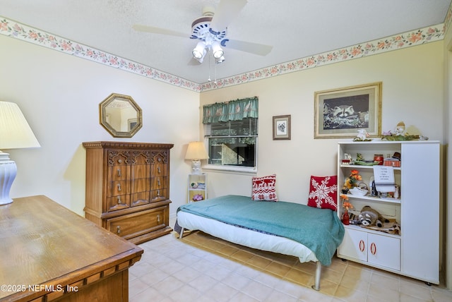 bedroom featuring ceiling fan and a textured ceiling