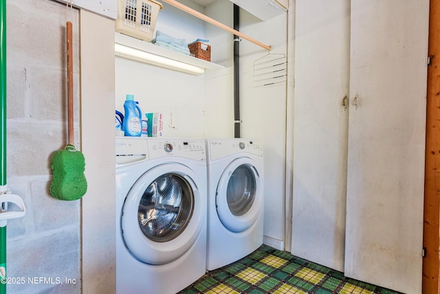 clothes washing area featuring washer and dryer