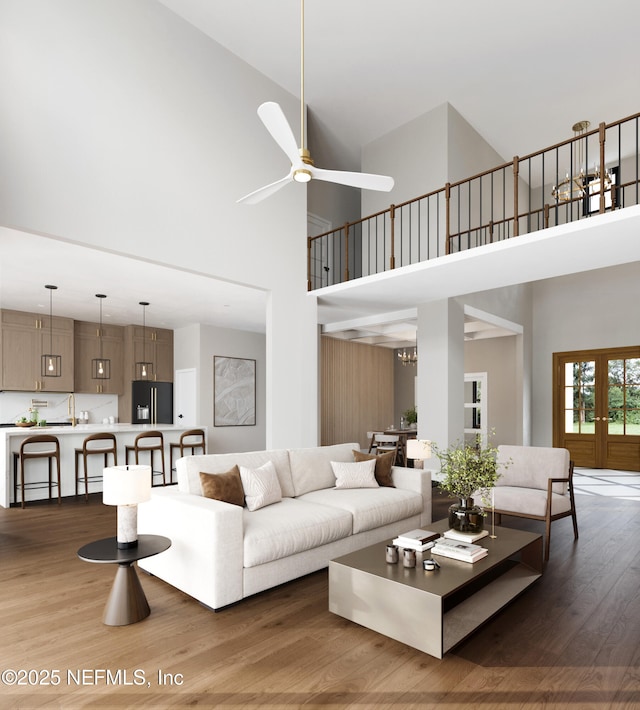 living room featuring dark wood-type flooring and high vaulted ceiling