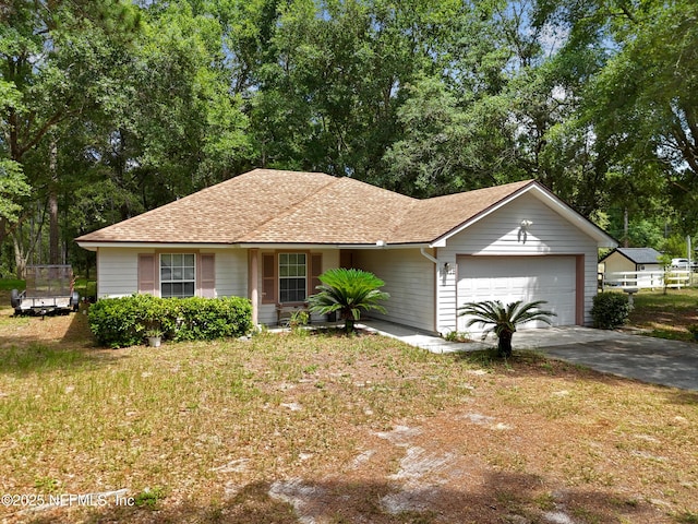 ranch-style home with a front yard and a garage