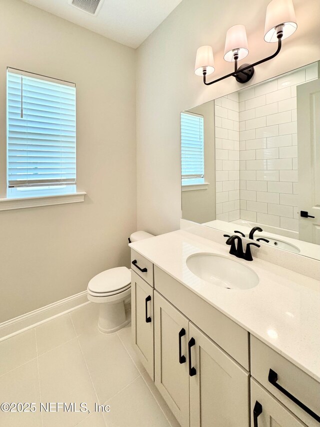 44 Vega Ct, Saint Augustine, FL 32095 - bathroom featuring vanity, tile patterned flooring, toilet, and a wealth of natural light