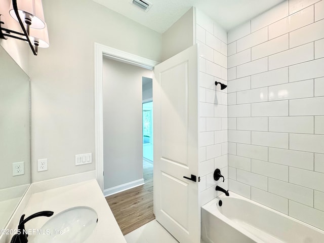 44 Vega Ct, Saint Augustine, FL 32095 - bathroom featuring visible vents, vanity, wood finished floors, and shower / washtub combination