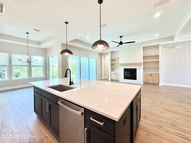 44 Vega Ct, Saint Augustine, FL 32095 - kitchen with baseboards, a raised ceiling, a sink, light wood finished floors, and dishwasher