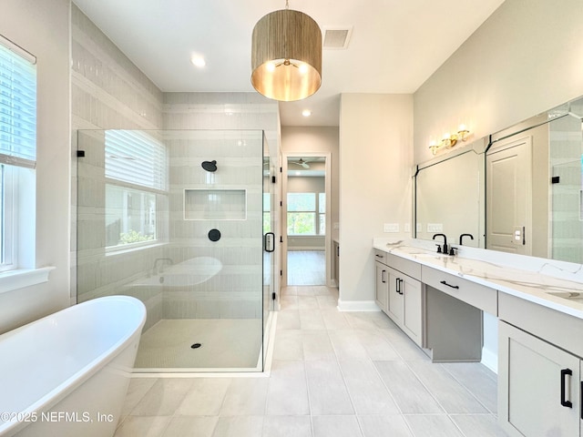 44 Vega Ct, Saint Augustine, FL 32095 - bathroom with double vanity, a freestanding bath, a shower stall, a sink, and tile patterned floors
