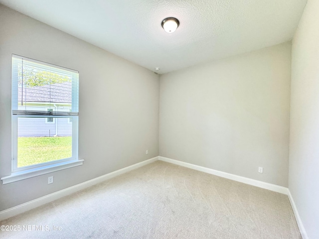 44 Vega Ct, Saint Augustine, FL 32095 - spare room with baseboards, a textured ceiling, and light carpet