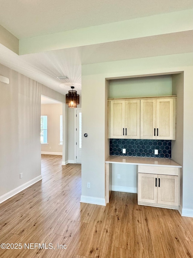 44 Vega Ct, Saint Augustine, FL 32095 - kitchen featuring decorative backsplash, light brown cabinets, light wood-style floors, baseboards, and light countertops