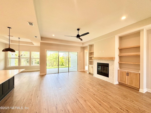 44 Vega Ct, Saint Augustine, FL 32095 - unfurnished living room featuring baseboards, light wood-style floors, ceiling fan, and a fireplace